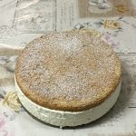 Cheese-cream cake sitting on a tablecloth