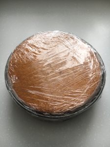 Assembled cake in plastic wrap