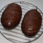 Rye bread formed into two loaves and glazed