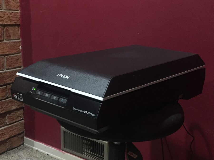 The Epson scanner sitting on a stool.