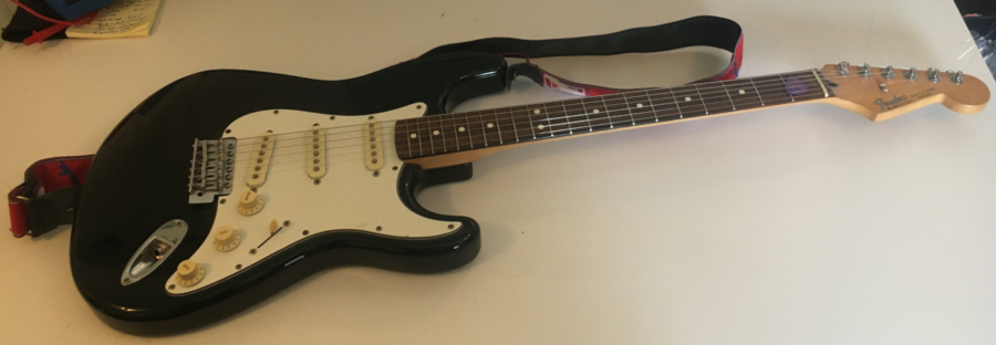 A Mexican Stratocaster sitting on a white background after having had the input jack repaired